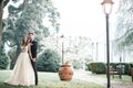 Wedding couple kissing in the park in the rain Royalty Free Stock Photo