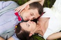 Wedding couple in love lying in green grass in summer meadow Royalty Free Stock Photo