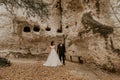 wedding couple in love man and woman walking in autumn forest background of stone rocks Royalty Free Stock Photo