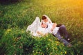 Wedding couple in love on sunset meadow full of flowers Royalty Free Stock Photo