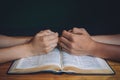 Wedding couple or marriage, praying over the open bible.