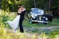 A wedding couple with old car Royalty Free Stock Photo