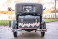 Wedding Couple in Oldtimer Ford Typ A Tudor Sedan 1928 during a Wedding Decorated Royalty Free Stock Photo