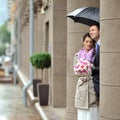 Wedding couple in a rainy day hiding from rain Royalty Free Stock Photo