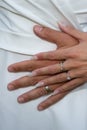 Wedding couple rings fingers bride and groom hands on marriage wed white dress background Royalty Free Stock Photo