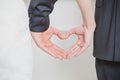 Wedding couple showing shape of heart from their Royalty Free Stock Photo