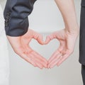 Wedding couple showing shape of heart from their hands. Royalty Free Stock Photo