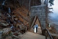 Wedding couple softly kiss on the wooden bridge. Misty day in mountains