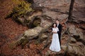 Wedding couple standing in the mountains against the sky. Cute romantic moment. Best day in the life of the bride. Royalty Free Stock Photo