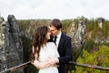 Wedding couple standing in the mountains against the sky. Cute romantic moment. Best day in the life of the bride. Royalty Free Stock Photo