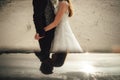 Wedding couple standing on sandy beach and hugging. Bride and groom together. Collage, mirror reflection. Wedding day Royalty Free Stock Photo