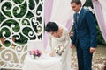 Wedding couple standing under an arch of fresh flowers Royalty Free Stock Photo