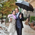 Wedding couple on their wedding day by the rain Royalty Free Stock Photo