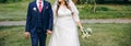 Wedding couple walking in the green park. Curvy bride in white lace dress and groom are holding hands. Overweight happy people. Royalty Free Stock Photo