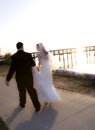 Wedding couple walking into sunset Royalty Free Stock Photo