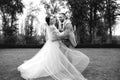 Wedding couple walks in the park and dances, the bride and groom have fun Royalty Free Stock Photo