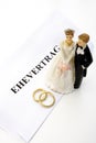 Wedding couples figurines standing on magisterial form text Royalty Free Stock Photo