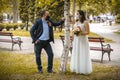 Wedding couples in medical masks poses in park Royalty Free Stock Photo