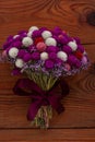 Wedding creative dried flowers bouquet on wooden background. Country purple red white flowers bunch. Floral crafts