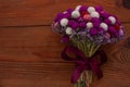 Wedding creative dried flowers bouquet on wooden background. Country purple red white flowers bunch. Floral crafts