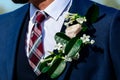 Wedding day. Beautiful creative groom boutonniere on the suit of