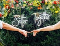 Wedding day. Bride and groom, love concept. Young family. Sign `Better together`. Newlyweds hands. Outdoor wedding ceremony. Royalty Free Stock Photo
