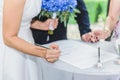 Wedding day. Bride signs on marriage certificate Royalty Free Stock Photo