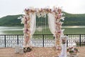 Wedding day, ceremony place for the bride and groom, decor, flowers. Concept of decor, wedding arch is decorated with