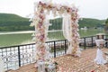 Wedding day, ceremony place for the bride and groom, decor, flowers. Concept of decor, wedding arch is decorated with