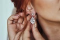 Wedding day. Earrings close-up in the hands of the bride. jewelry accessories