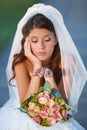 Wedding day jitters. a young bride looking upset while sitting down and holding her bouquet.