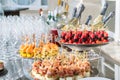 Wedding day recepton. Buffet table. Catering service. Plates with sweet canape with berries, raspberry, blackberry, ham,shrimp. Royalty Free Stock Photo