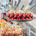 Wedding day recepton. Buffet table. Catering service. Plates with sweet canape with berries, raspberry, blackberry, ham,shrimp. Royalty Free Stock Photo