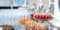 Wedding day recepton. Buffet table. Catering service. Plates with sweet canape with berries, raspberry, blackberry, ham,shrimp. Royalty Free Stock Photo