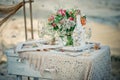 Wedding decor with bottle, glasses, flowers, sea cockleshells an