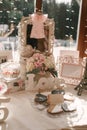 Wedding decor candy bar: the word love, small candy in a glass vase, cookies in the form of the bride and groom, photo frames