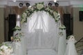 Wedding arch, decorated with flowers, musical speakers and searchlights in the background