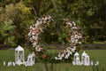Wedding decor with flowers and candles. This is round arch of foliage and flowers. Outside wedding ceremony Royalty Free Stock Photo