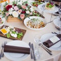 Wedding decor. Flowers in the restaurant, food on the table Royalty Free Stock Photo
