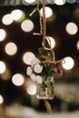 The wedding decor hangs near the candlelit dinner table.Dinner with candles