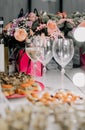 Wedding Decor In Pink Bronze - Green Dry Leaves, Flowers, White Table Cloth, Silk, Burning Candle, Green Carpet, Wine Glass Pink Royalty Free Stock Photo