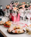 Wedding Decor In Pink Bronze - Green Dry Leaves, Flowers, White Table Cloth, Silk, Burning Candle, Green Carpet, Wine Glass Pink Royalty Free Stock Photo