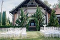 Wedding decor, a place for a wedding ceremony in nature, in the garden. Wedding arch made of fresh flowers, floristry. Royalty Free Stock Photo