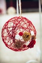 Wedding decor, a red ball glued from threads and flowers in beige, white and red Royalty Free Stock Photo