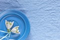 Wedding decor. White ceramic flowers on a blue fabric background Royalty Free Stock Photo