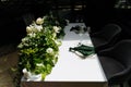 wedding decor with white roses and greenery. Wedding floral table decoration with candles in transparent vases