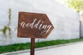 Wedding decor. Wooden plaque with the inscription in paint Wedding. Wood hand made signboard, welcome wedding decoration Royalty Free Stock Photo
