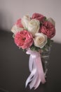 Bouquet of white and red roses with pink ribbons in a glass vase Royalty Free Stock Photo