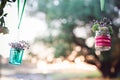 Wedding decoration of glas bottles with flowers hanging Royalty Free Stock Photo