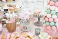 Wedding decoration with pastel colored cupcakes, meringues, muffins and macarons Royalty Free Stock Photo